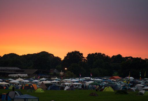 The sun setting behind the camping site of the Metal Festival Wacken Open Air Festival in Wacken, Germany, 01 August 2017. The Wacken Open Air festival takes place between 03 and 05 August 2017. Photo: Christophe Gateau\/