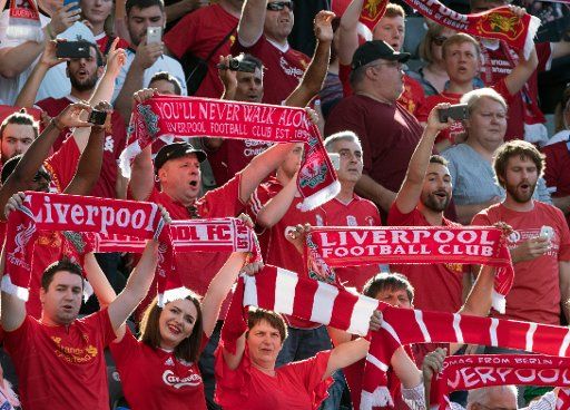 Liverpool fans sing and wave scarves in the stands ahead of the international club friendly soccer match between Hertha BSC and FC Liverpool in the Olympia Stadium in Berlin, Germany, 29 July 2017. Photo: Soeren Stache\/