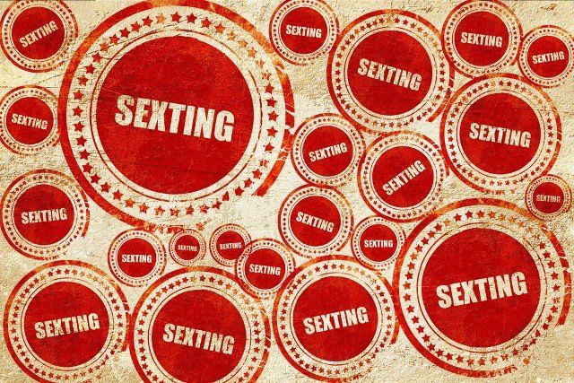 sexting, red stamp on a grunge paper texture