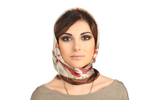 Beautiful woman in a scarf on her head isolated on white background