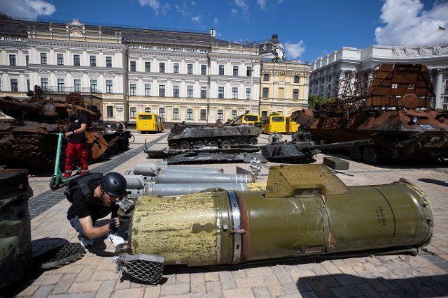 People walk through the exhibition of destroyed Russian weapons and tanks, which are installed in the Saint Michael square, in kyiv, Ukraine, 15 June 2022. Russian armored vehicles, tanks and missiles have become an attraction for people, where many come to take pictures. EFE\/ Orlando Barría