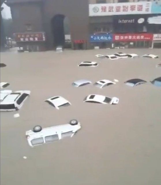 Vehicles floated in flood water in Central China\