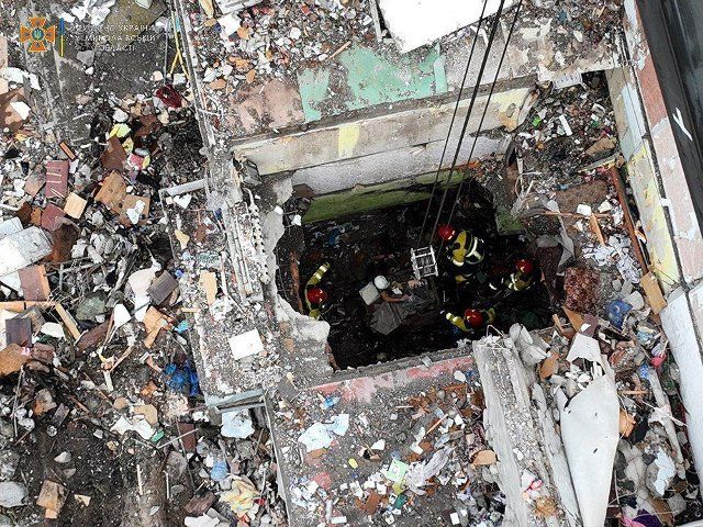 Ukraine search and rescue team work through the rubble on the stairwell following a missile strike in a high-rise building in Nikolaev, a city near the Black Sea in southern Ukraine, on July 1, 2022. (State Emergency Service of Ukraine \/EYEPRESS