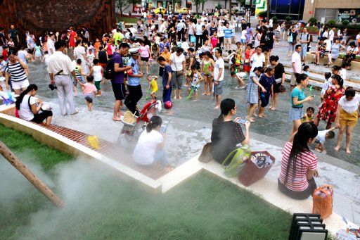 People seek coolness in a water-theme square in the city in southwest China\