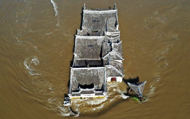 A view of the 700-year-old Guanyin Temple, built on a rock in the Yangtze River, in the flood in Ezhou city in central China\