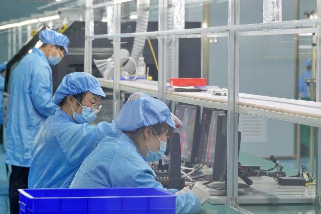 Women work at an electronics assembly in Yantai in east China\