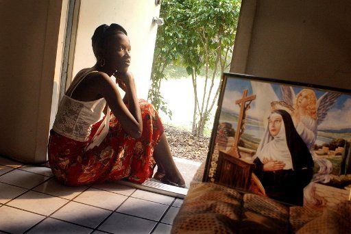 KRT US NEWS STORY SLUGGED: HAITIANS-DETAINEES KRT PHOTOGRAPH BY CANDACE BARBOT\/MIAMI HERALD (FORT LAUDERDALE OUT) (December 18) Haitian immigrant Chimene Noel relies on her faith and natural tenacity to carry her through as she struggles to help her...