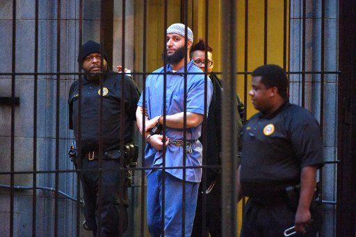 Officials escort "Serial" podcast subject Adnan Syed from the courthouse following the completion of the first day of hearings for a retrial in Baltimore on Wednesday, Feb. 3, 2016. (Karl Merton Ferron\/Baltimore Sun\/TNS)