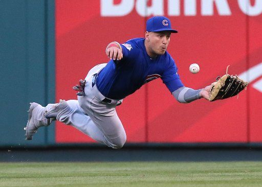 Chicago Cubs center fielder Albert Almora Jr. dives but is unable to catch a single by the St. Louis Cardinals\