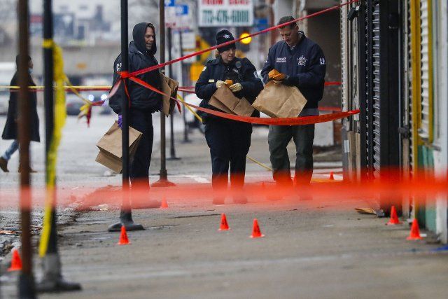 Chicago police recover evidence as they investigate a shooting in which eight people were shot, one fatally, in Chicago\