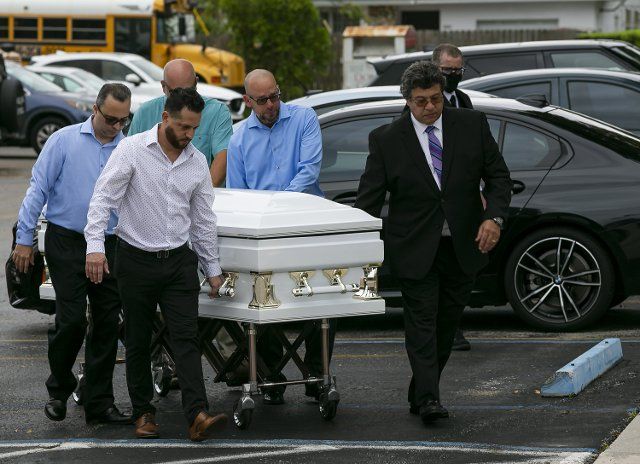 Pallbearers wheel the casket of Anaely Rodriguez as they arrive to her funeral service at St. Joseph Catholic Church in Surfside, Florida on Tuesday, July 6, 2021. Rodriguez, her husband, Marcus Guara, and daughters, Lucia and Emma, died during the Champlain Towers South condo collapse that happened on Thursday, June 24, 2021. (Matias J. Ocner\/Miami Herald\/TNS