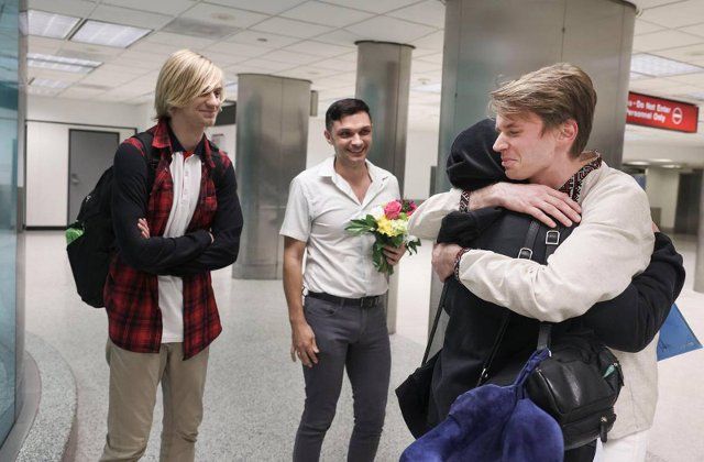 Roman Zhenzhirov, right, hugs his mother, Nataliia Zhenzhirova, while his husband, Roman Shyshkin, center, smiles with Zhenzhirovâs brother, Arsenii, 17, left, who entered the United States with nothing more than a backpack on Tuesday, June 21, 2022, at Miami International Airport. Arsenii and Nataliia evacuated their city of Zhashkiv in central Ukraine and fled to Romania, Poland and then Germany before coming to the U.S. (Alie Skowronski\/Miami Herald\/TNS