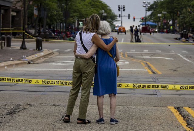 Shana Gutman and her mom Eadie Bear, lifelong residents of Highland Park, Illinois, take a look at the Central Avenue scene Tuesday, July 5, 2022, the day after a mass shooting at the Fourth of July parade. They said they frequently attend the parade but didn\
