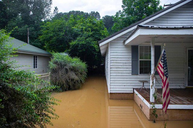 Receding flood waters surround a home in Whitesburg, Kentucky, on Friday, July 29, 2022. (Ryan C. Hermens\/Lexington Herald-Leader\/TNS