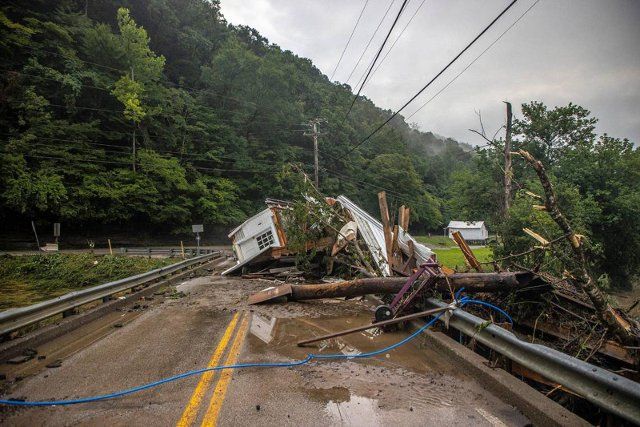 A house rests on a bridge near the Whitesburg Recycling Center in Letcher County, Kentucky, on Friday, July 29, 2022. (Ryan C. Hermens\/Lexington Herald-Leader\/TNS