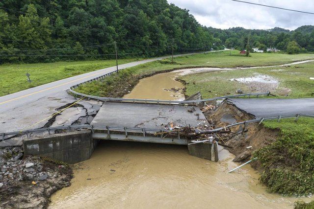 A bridge across Grapevine Creek at Chavies School Road in Perry County, Kentucky, is heavily damaged Tuesday, Aug. 2, 2022, following catastrophic flooding last week. (Ryan C. Hermens\/Lexington Herald-Leader\/TNS