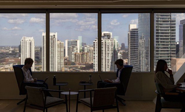 Employees work with a skyline view inside Accentureâs new offices on Aug. 30, 2022, at 500 W. Madison St. in Chicago\