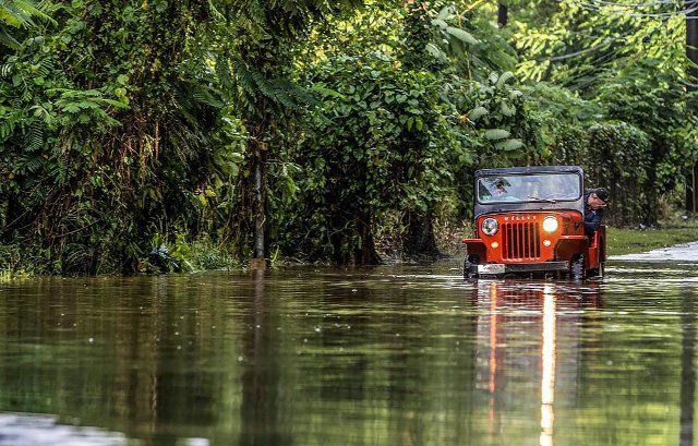 Juan Antonio Molina drives his old Jeep through a road flooded in Toa Alta on Tuesday, September 20, 2022, two days after Hurricane Fiona made landfall in Puerto Rico. (Pedro Portal\/El Nuevo Herald\/TNS