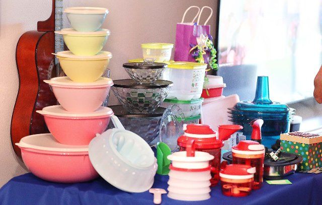 Tupperware items, including a set of "retro" storage containers at left, rest on a table during a Tupperware party in Sebastian, Florida, on Wednesday, May 18, 2022. A curated selection of Tupperware offerings became available at Target stores and Target.com, CEO Miguel Fernandez revealed in a post on Linkedin. (Stephen M. Dowell\/Orlando Sentinel\/TNS