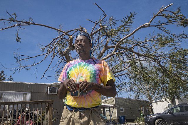 Shawn Hunte, a resident at Sunnyland Court Mobile Home Park in San Carlos Island talks about his ordeal to survive a top off the tree behind him as Hurricane Ian hit Florida\