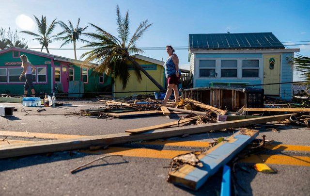 Donna LaMountain, 51, surveys damage on Pine Island Road on Sept. 29, 2022, in Matlacha, Florida, in the wake of Hurricane Ian. (Matias J. Ocner\/Miami Herald\/TNS