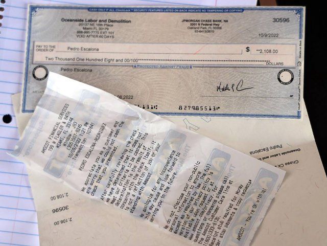 Pedro Escalona, who can not cash his check because he is without identification, holds on to the receipt that states the reason for check not being cashed. He was one of the Venezuelan migrants recruited from a shelter in New York to work on Hurricane Ian clean up in Fort Myers, Florida. (Carl Juste\/Miami Herald\/TNS