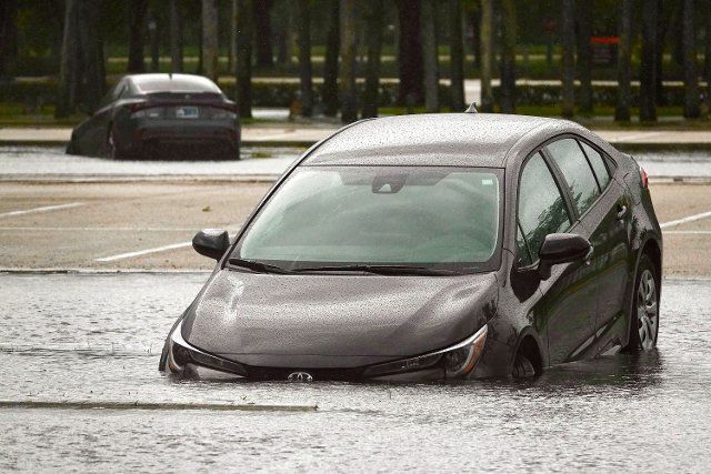 A car sits parked in a flooded parking lot at Sawgrass Mills in Sunrise, Florida, on Sept. 28, 2022, after parts of South Florida received nearly 10 inches of rain over three days from Hurricane Ian. (Joe Cavaretta\/South Florida Sun Sentinel\/TNS