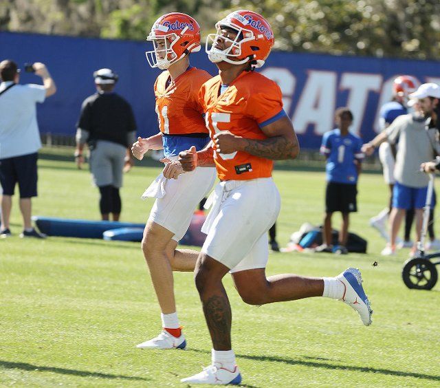 Florida quarterbacks Anthony Richardson (15) and Jalen Kitna (11) jog during a March 17 practice at the Sanders Football Practice Field in Gainesville, Florida. (Stephen M. Dowell\/Orlando Sentinel\/TNS