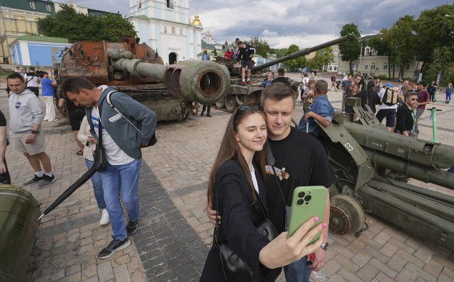 People take photos during their visit to a square in Kyiv, where destroyed Russian tanks and armored vehicles have been put on display, on June 5, 2022. (Kyodo) ==Kyodo