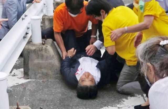 Photo taken in Nara, western Japan, on July 8, 2022, shows former Japanese Prime Minister Shinzo Abe fallen on the ground on the side of a road after being shot from behind by a man. Abe was giving a stump speech for the July 10 House of Councillors election at the time of the attack. He was pronounced dead at a local hospital later in the day. (No trimming permitted) (Kyodo) ==Kyodo