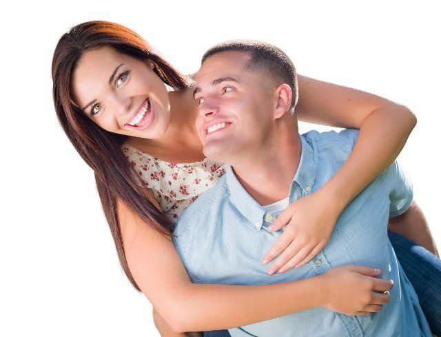 mixed-race romantic military couple piggyback portrait isolated on