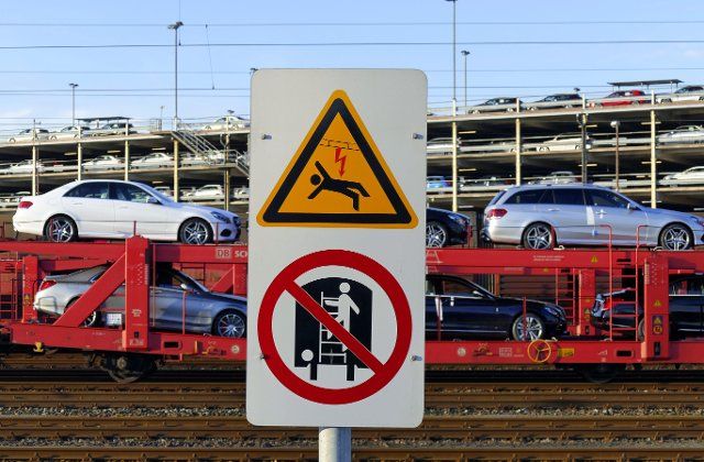 Cars intended for export on a railway train in Bremerhaven, signs (Attention electrocution) (Climbing on the wagon prohibited), Germany