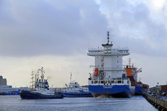 Tugboats at work in the Labrador harbour of Bremerhaven, cargo ship Grete Sibum, Germany