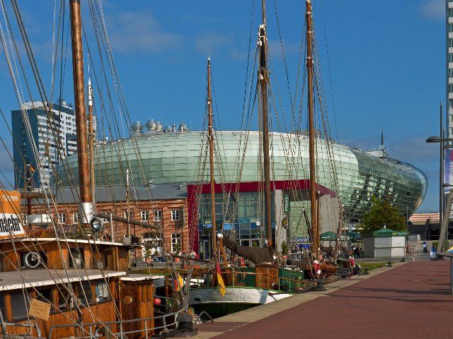 Old sailing ships in the harbour with the Klimahaus in the background, Bremerhaven, Germany