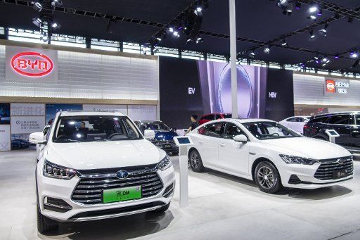 --FILE--People visit the stand of Chinese top electric carmaker BYD during the Shanghai Pudong International Automotive Exhibition 2018 in Shanghai, China, 28 September 2018. Chinese top electric carmaker BYD Co, which is backed by US investor Warren Buffett, said on Monday it expected full-year net profit to drop almost one-third as competition heats up in the world\