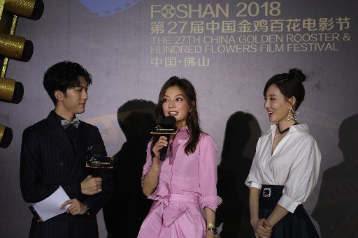 Chinese actress Zhao Wei, center, arrives on the red carpet ceremony of the 27th China Golden Rooster & Hundred Flowers Film Festival in Foshan city, south China\