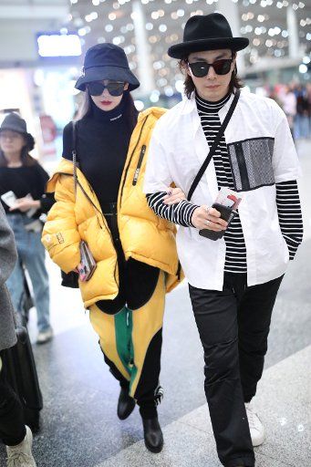 Chinese singer and actress Qi Wei, left, and her husband Lee Seung-hyun show up at the Beijing Capital International Airport in Beijing, China, 17 September 2019. Qi Wei\