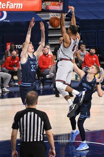 iSPOKANE, WA - FEBRUARY 20: Gonzaga Gonzagaard Aaron Cook (4) dunks as he is defended by San Diego Gonzagaard Joey Calcaterra (2) during the game between the San Diego Toreros and the Gonzaga Bulldogs played at the McCarthey Athletic Center on February 20, 2021 in Spokane, Washington. (Photo by Robert Johnson\/Icon Sportswire