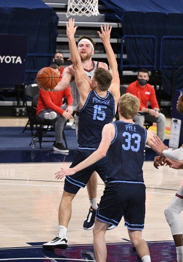 SPOKANE, WA - FEBRUARY 20: Gonzaga forward Drew Timme (2) is fouled as he puts up a shot under the arm of San Diego center Vladimir Pinchuk (15) during the game between the San Diego Toreros and the Gonzaga Bulldogs played at the McCarthey Athletic Center on February 20, 2021 in Spokane, Washington. (Photo by Robert Johnson\/Icon Sportswire