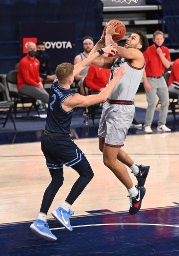 SPOKANE, WA - FEBRUARY 20: Gonzaga forward Anton Watson (22) scores while being fouled by San Diego Gonzagaard Joey Calcaterra (2) during the game between the San Diego Toreros and the Gonzaga Bulldogs played at the McCarthey Athletic Center on February 20, 2021 in Spokane, Washington. (Photo by Robert Johnson\/Icon Sportswire