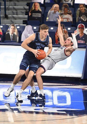 SPOKANE, WA - FEBRUARY 20: Gonzaga forward Corey Kispert (24) goes to the floor as San Diego center Vladimir Pinchuk (15) makes a move to the basket during the game between the San Diego Toreros and the Gonzaga Bulldogs played at the McCarthey Athletic Center on February 20, 2021 in Spokane, Washington. (Photo by Robert Johnson\/Icon Sportswire