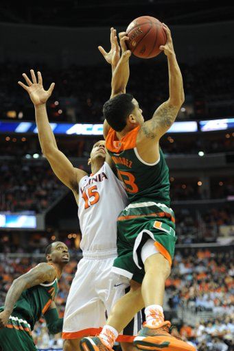 11 March 2016: Miami Hurricanes guard Angel Rodriguez (13) rebounds the ball from Virginia Cavaliers guard Malcolm Brogdon (15) in the semifinal of the ACC Tournament at the Verizon Center in Washington, D.C. (Photograph by Mark Goldman\/Icon ...