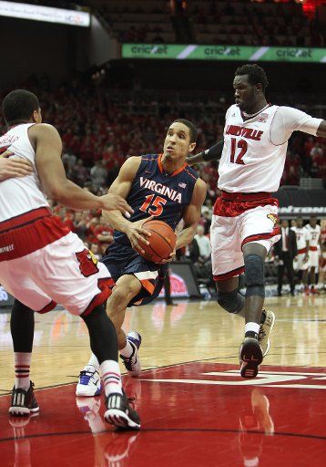 07 March 2015: Virginia Cavaliers guard Malcolm Brogdon (15) drives to the basket against Louisville Cardinals forward\/center Mangok Mathiang (12) in a game between the University of Virginia Cavaliers and the University of Louisville Cardinals in ...