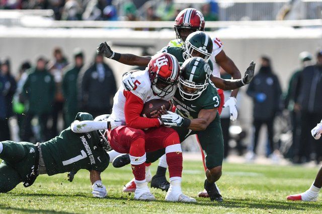 EAST LANSING, MI - NOVEMBER 19: Michigan State Spartans safety Xavier Henderson (3) and his teammates make a stop of Indiana Hoosiers quarterback Dexter Williams II (5) during a college football game between the Michigan State Spartans and Indiana Hoosiers on November 19, 2022 at Spartan Stadium in East Lansing, MI (Photo by Adam Ruff\/Icon Sportswire