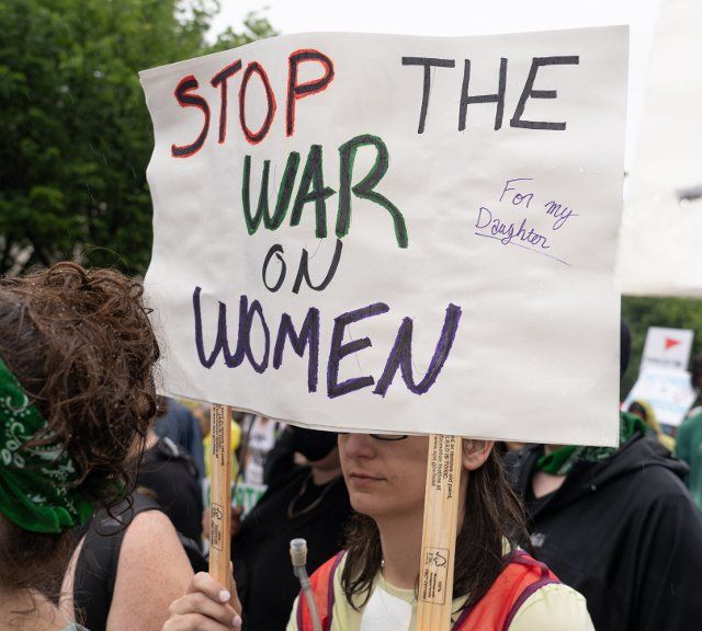 "Stop the war on Women" reads the sign. Abortion rights activists marched to the White House in Washington D.C. on July 9, 2022 to stage a mass sit-in. (Photo by Jeff Malet