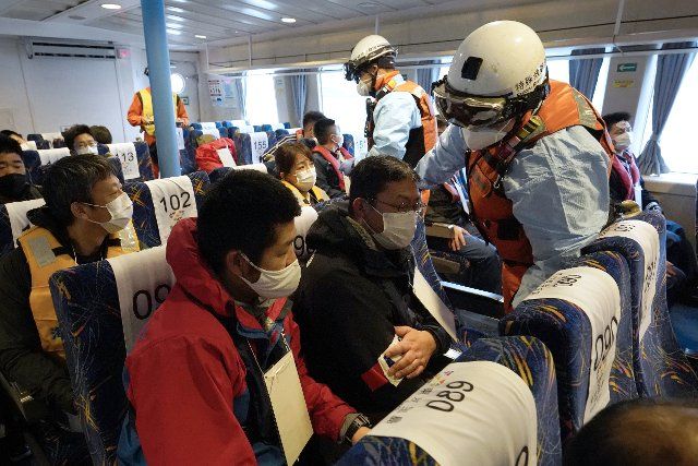A passenger boat hold an accident-response drill at the Tokyo Port in Tokyo, Japan, December 7, 2021. Assuming that a high-speed vessel collided with an obstacle and many people were injured, Japan Coast Guard, Tokyo Fire Department and Tokyo Metropolitan Police Department cooperated to rescue and transport the injured people to medical institutions. 127 people participated in the drill, including 9 ships and 1 aircraft. JIJI PRESS PHOTO \/ MORIO TAGA