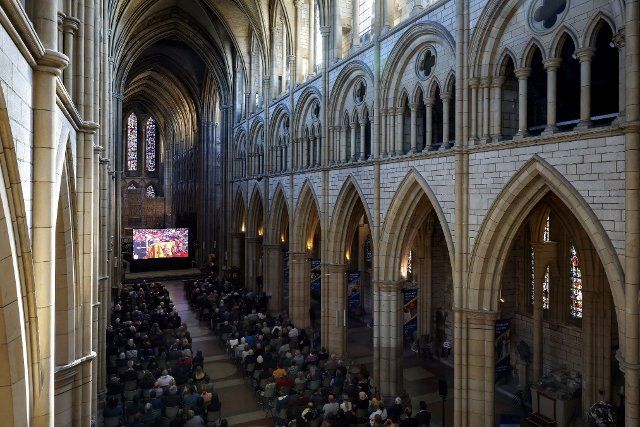 People fill Truro Cathedral to watch the funeral of Queen Elizabeth II on a giant screen erected inside the cathedral. Monday 19th September 2022