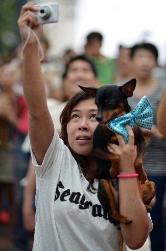 Audeince members look on as Dog whisperer Cesar Millan (unseen) talks about dog behaviour at the National Geographic Channel Rescue day at Stanley Plaza in Hong Kong. 10MAY14 Antony