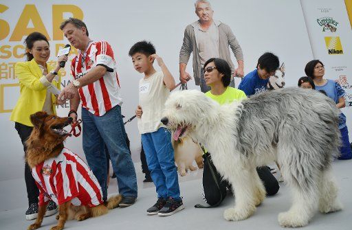 Attendeed and their canines are interviewd on stage before dog whisperer Cesar Millan talks about dog behaviour at the National Geographic Channel Rescue day at Stanley Plaza in Hong Kong. 10MAY14 == Antony DICKSON ==