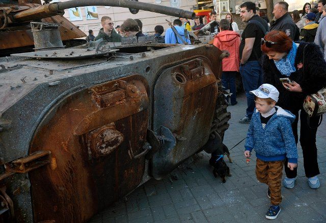 VINNYTSIA, UKRAINE - MAY 5, 2022 - People look at a Russian tank and an APC destroyed in heavy fighting near Bucha and Irpin, Kyiv Region, that are put on display as a show of defiance and a reminder that the war is near in Yevropeiska Square, Vinnytsia, central Ukraine. This photo cannot be distributed in the Russian Federation. \/\/UKRINFORMAGENCY_08\/2205061207\/Credit:Oleksandr Lapin\/Ukrinform\/SIPA